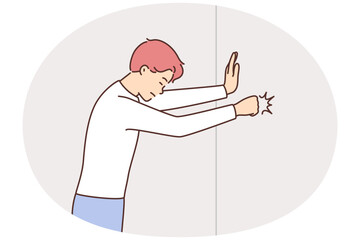 Angry man hit wall with fist © Valery
