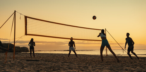 Summer games: Friendly beach volleyball match at sunset