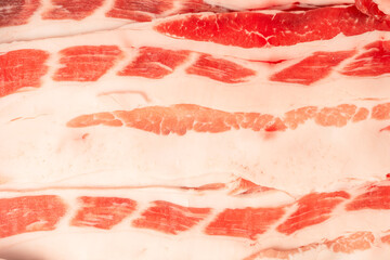 Tasty raw bacon as a background.