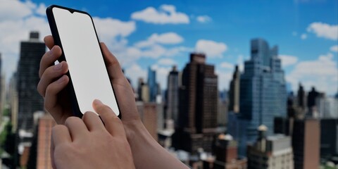 Smartphone with blank screen over cityscape, ideal for urban tech promotions