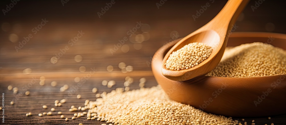 Poster A wooden table serves as the backdrop for a copy space image featuring a spoonful of natural sesame seeds