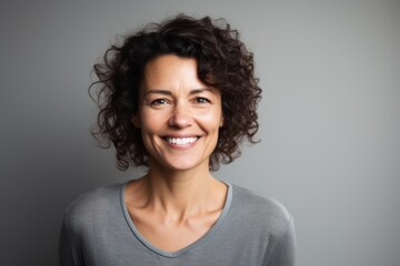 Portrait of a happy woman in her 40s smiling at the camera isolated on white background
