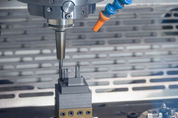 The CNC milling machine cutting the graphite electrode parts.
