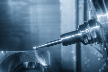 The 5-axis CNC milling machine  cutting the automotive part with solid ball end mill tool.