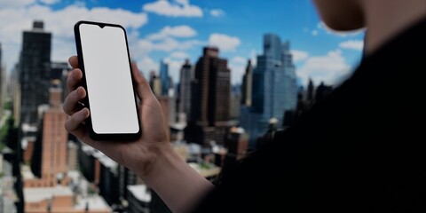Smartphone with blank screen over cityscape, ideal for urban tech promotions