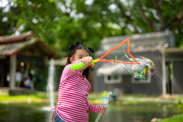 Young Girl Playing with Giant Bubble Wand