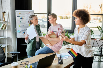 Diverse group of hardworking businesswomen discussing ideas at desk in modern office.