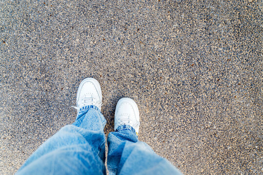 White shoes on urban grunge background of asphalt  - Powered by Adobe