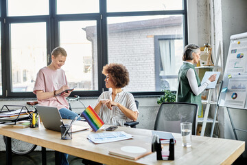 Cheerful diverse female professionals working together on their project in office.