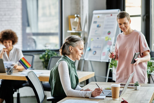 Dedicated diverse businesswomen discussing their project in office.