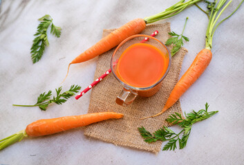Orange carrot juice and fresh carrots 