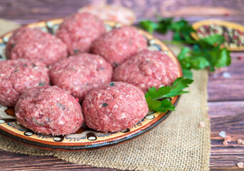 Beef raw meatballs in traditional Bulgarian plate 