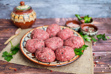 Beef raw meatballs in traditional Bulgarian plate 