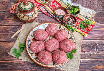 Beef raw meatballs in traditional Bulgarian plate 