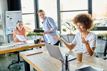 Cheerful diverse group of businesswomen collaborating in their office.