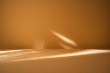 LIight reflection on smooth brown wall and empty table for branding products, presentation, food or...