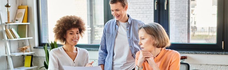 Diverse group of hardworking businesswomen discussing plans around a table in a modern office.