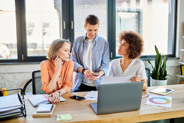 Fototapeta premium Diverse group of businesswomen working on laptop at table.