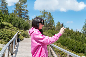Traveler Woman taking pictures in the spring mountain 