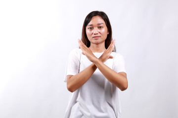 Portrait of young asian woman showing stop, cross prohibition sign, forbid smth, refusing, standing...