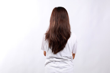 Back view of asian woman in casual standing over isolated background, standing backwards