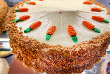 Carrot cake with walnuts, iced with cream cheese. Sweet dessert.