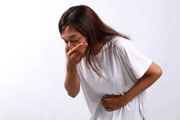Young Asian Woman suffering from stomach ache and nausea on white background. Food poisoning