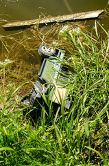 Old toy car dumped in the pond. High quality photo