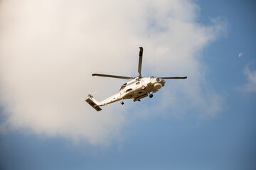 Modern helicopter in flight against blue sky. New engine technology for rescue and transport. Pilot...