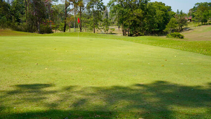 View of Golf Course with beautiful putting green. Golf course with a rich green turf beautiful scenery.