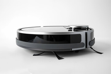 Obraz premium A sleek and compact robotic vacuum cleaner with intelligent obstacle detection and a large dustbin isolated on a solid white background.