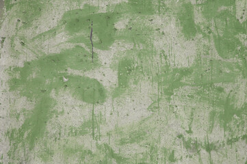 concrete wall and traces of green paint close-up