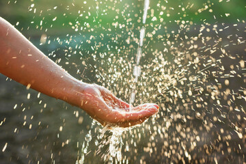 hand is holding a spray bottle of water