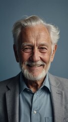 Obraz premium The gray-haired elderly man smiles happily. Indigo background.