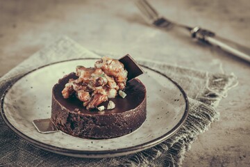 Chocolate tartlet with topping of caramelized nuts, almonds and pistachios