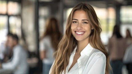 Obraz premium Smiling young woman in a casual white shirt, posing for a lifestyle portrait. Indoor setting with a blurred background. Approachable and professional look captured in a bright atmosphere. AI