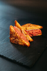 Meat sandwich on black background