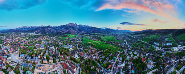 Aerial view of Tatra mountains and Zakopane town at sunset. Panoramic landscape with mountain...
