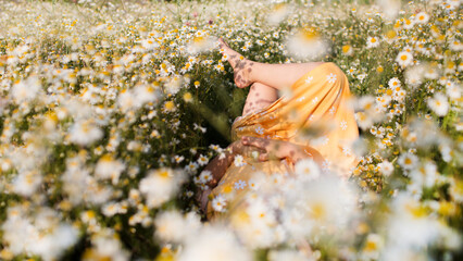 Child girl  lies in a meadow with a daisies in summer. Earth Day. World Environment Day. world...