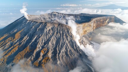 Aerial view of Ijen volcano on Java Island, Indonesia, showcasing its crater rim and sulfuric smoke.