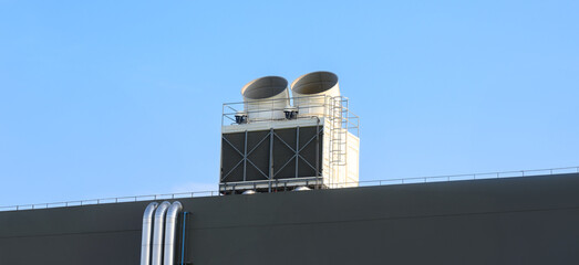 Exhaust vents of industrial air conditioning and ventilation units on roof top of large building