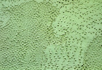 An amateurishly laid plaster on the wall of the building