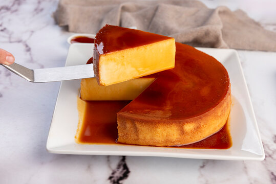 Homemade flan or Venezuelan cheese with whole caramel and in individual or large portions on white tableware