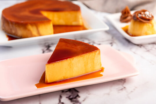 Homemade flan or Venezuelan cheese with whole caramel and in individual or large portions on white tableware
