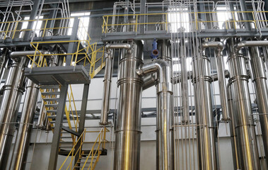 A complex network of pipes and vessels in a modern chemical processing facility.