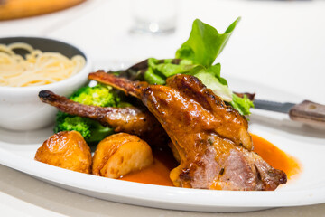 Lamb saddle with bone and pasta dish