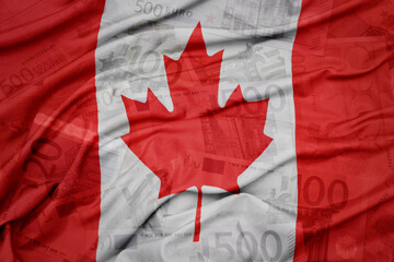 waving colorful national flag of canada on a euro money banknotes background. finance concept.