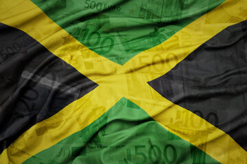 waving colorful national flag of jamaica on a euro money banknotes background. finance concept.