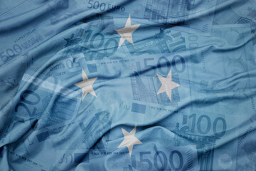 waving colorful national flag of Federated States of Micronesia on a euro money banknotes...