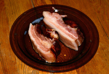 Cooked bacon on a plate on the table